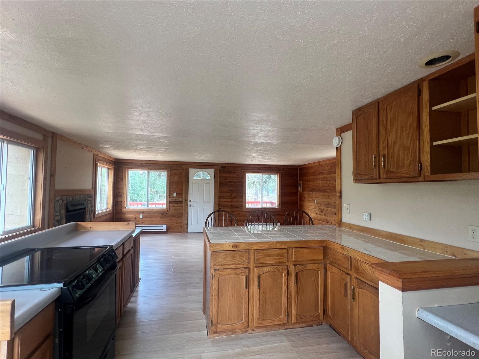 95 Appleby Street Bailey, CO 80421 - Photo 8 of 36 a kitchen with granite countertop a sink a stove and cabinets
