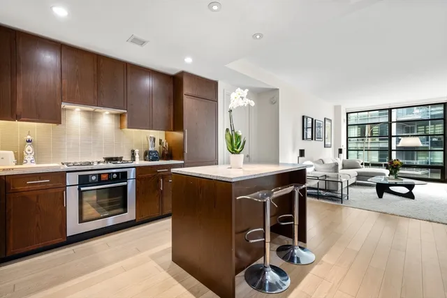 a kitchen with stainless steel appliances granite countertop a stove and a refrigerator