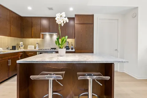 a kitchen with a sink a table and chairs in it