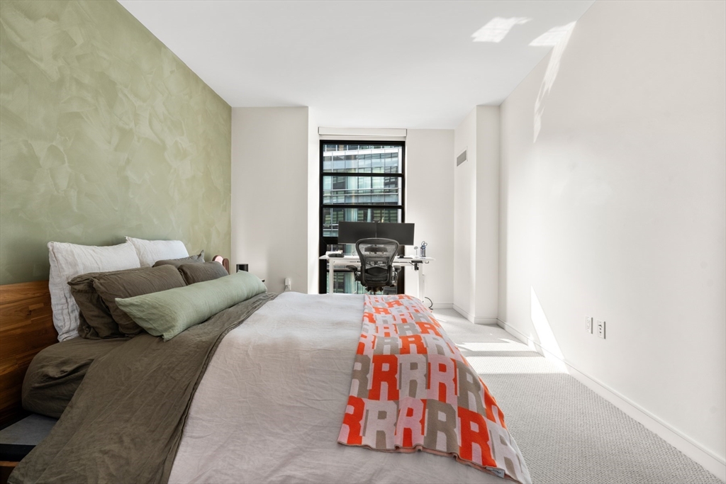 580 Washington Street, Unit 611 Boston, MA 02111 - Photo 17 of 39 a bedroom with a bed and a window