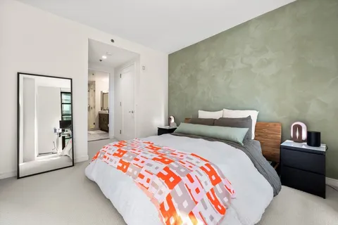 a bedroom with a bed and a couch