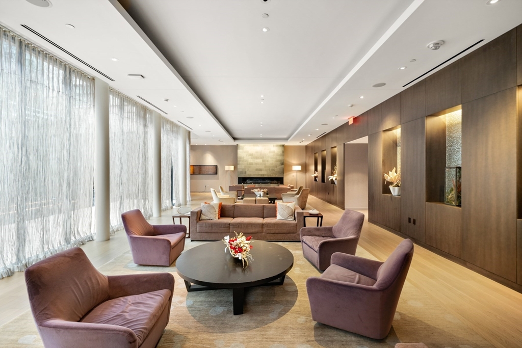 580 Washington Street, Unit 611 Boston, MA 02111 - Photo 28 of 39 a living room with furniture and a large window