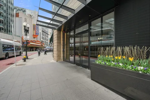 a view of a porch with a table and chairs and potted plants
