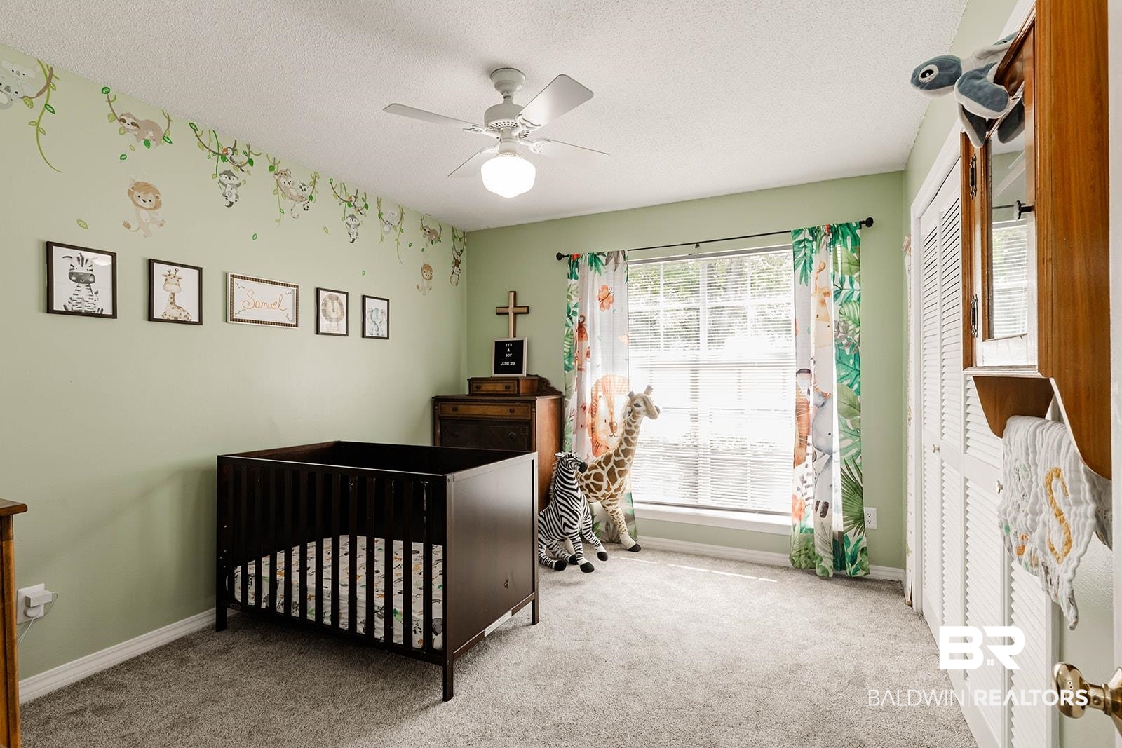 2920 Quail Creek Run Mobile, AL 36695 - Photo 23 of 33 Bedroom with carpet, a textured ceiling, ceiling fan, a nursery area, and a closet