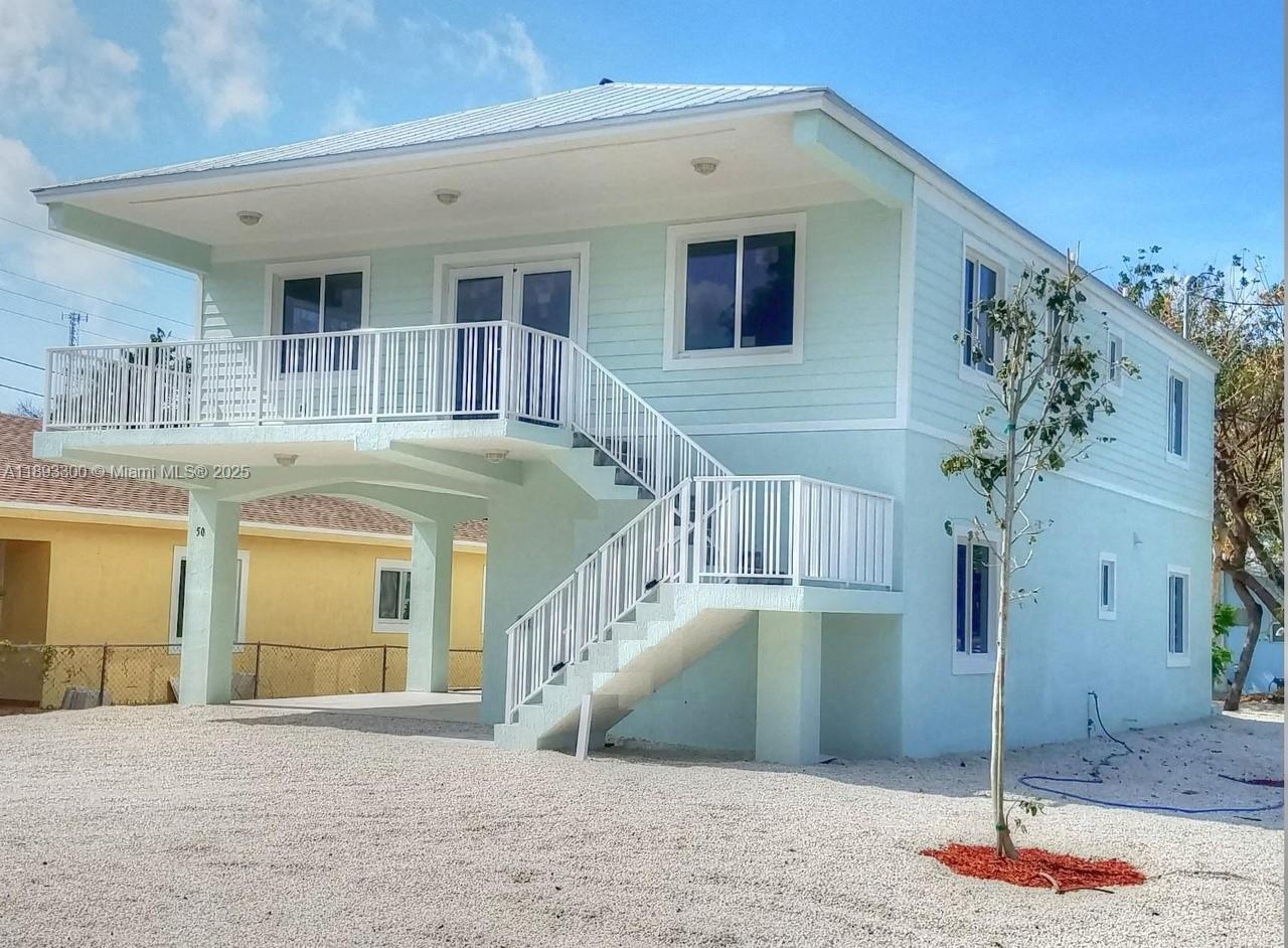 50 Orange Drive, Unit B Key Largo, FL 33037 - Photo 1 of 2 a view of a house with a swimming pool