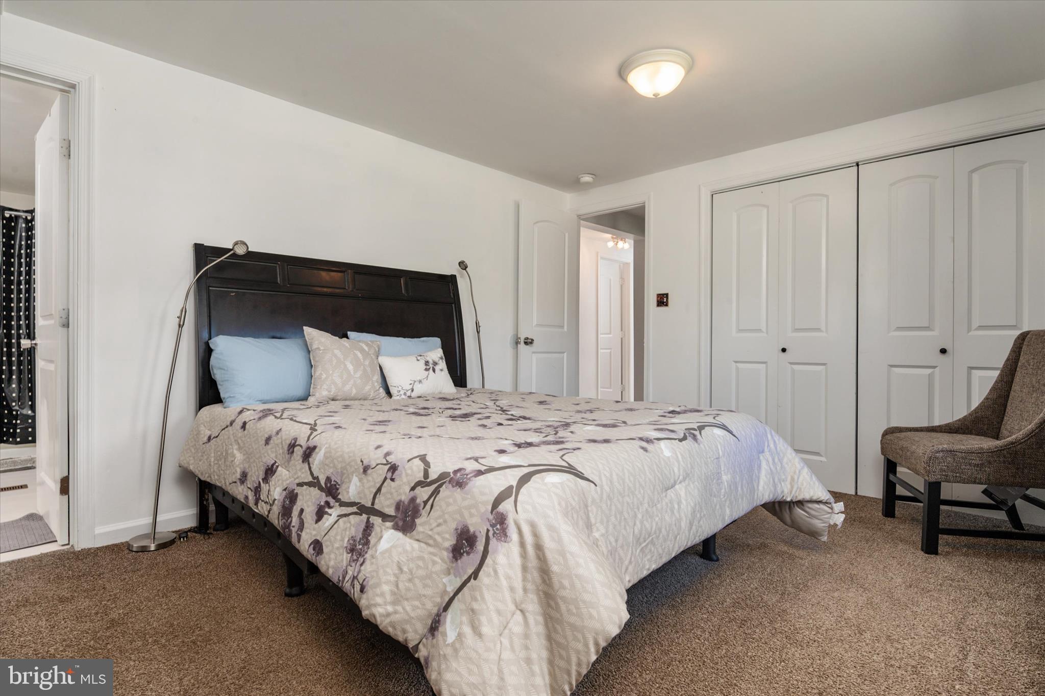 108 Wilson Road Grasonville, MD 21658 - Photo 17 of 38 a bedroom with a bed and a chair