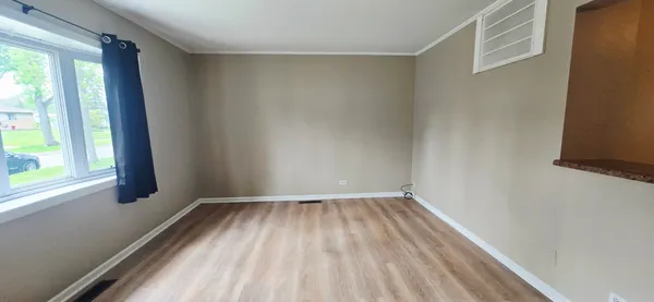 a view of a room with wooden floor and fence