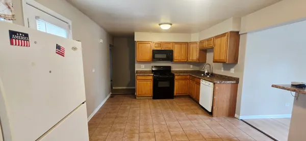 a kitchen with stainless steel appliances a refrigerator and a stove top oven