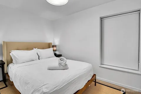 a bedroom with a bed and a window