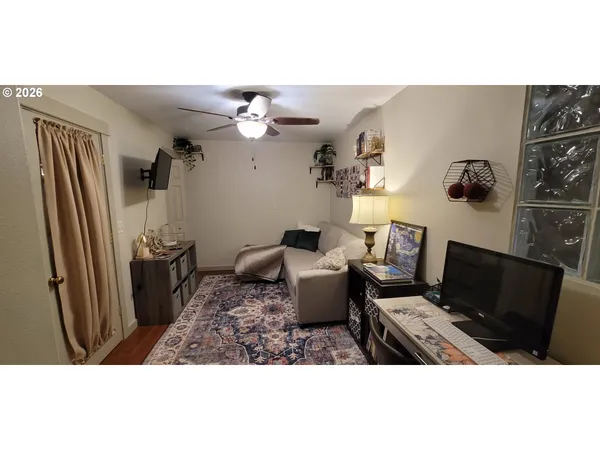 a view of a living room with furniture and a flat screen tv
