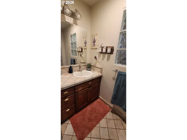 a spacious bathroom with a sink and a mirror