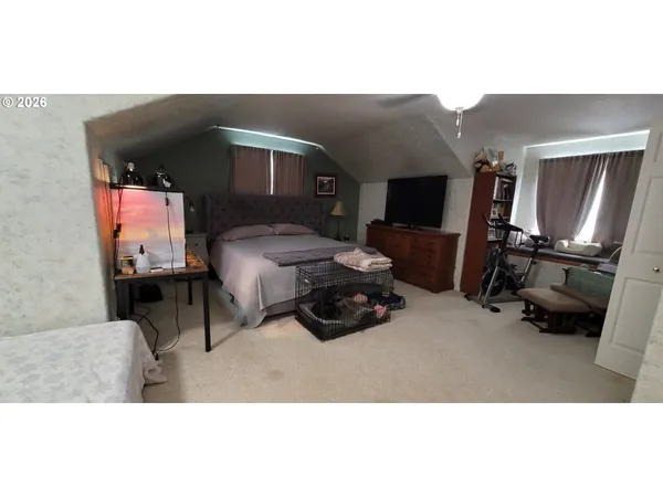 a bedroom with furniture and a flat screen tv