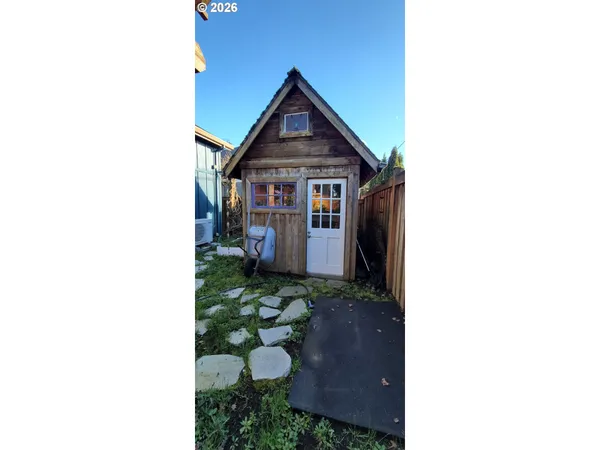 a view of a house with a yard and sitting area