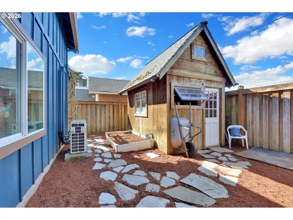 a view of a house with backyard and sitting area