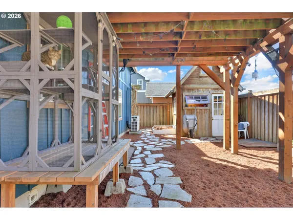 a backyard of a house with barbeque oven table and chairs