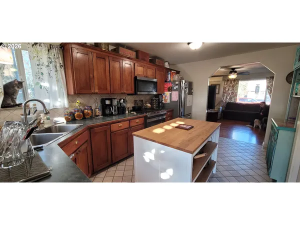 a kitchen with a refrigerator and a stove top oven