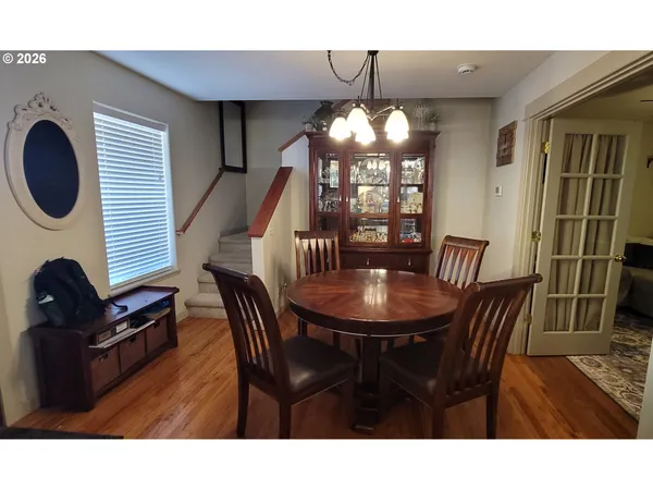 a view of a dining room with furniture and chandelier
