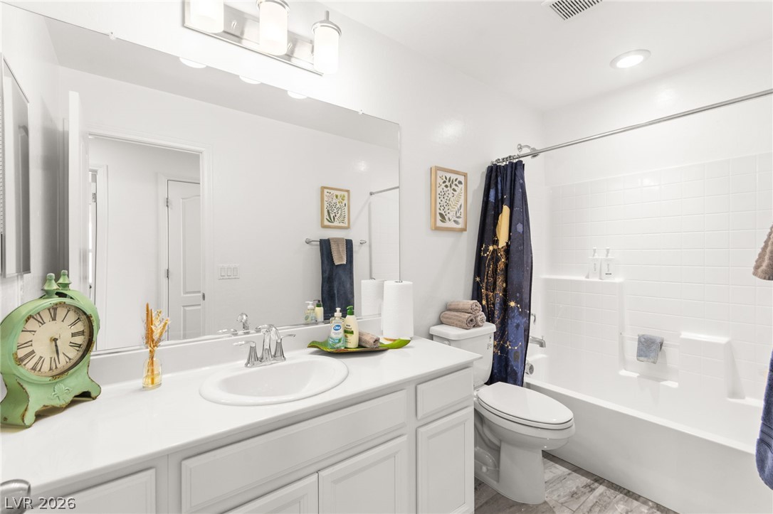 6435 Point Isabel Way Las Vegas, NV 89122 - Photo 37 of 57 White fixtures and a bright vanity create a refreshing ambiance in this well-appointed bathroom.