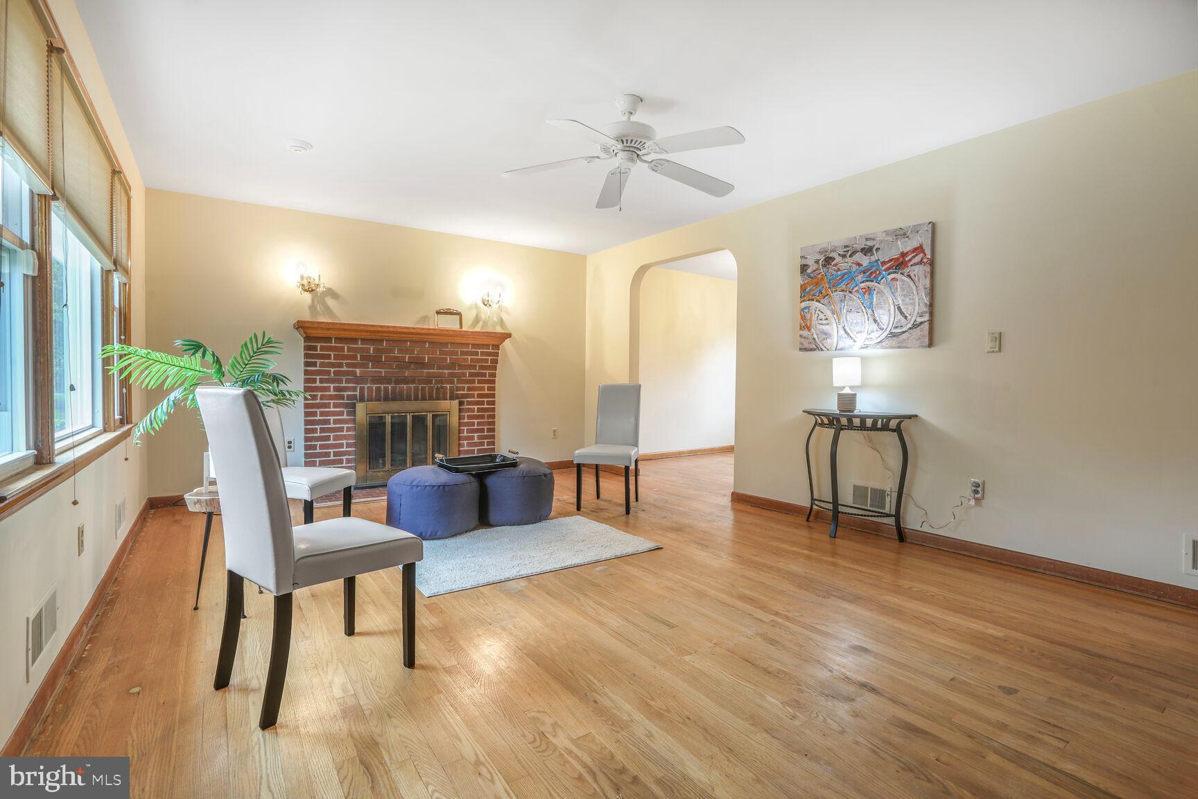 7423 Phelps Road Hanover, MD 21076 - Photo 2 of 28 a living room with furniture and a fireplace