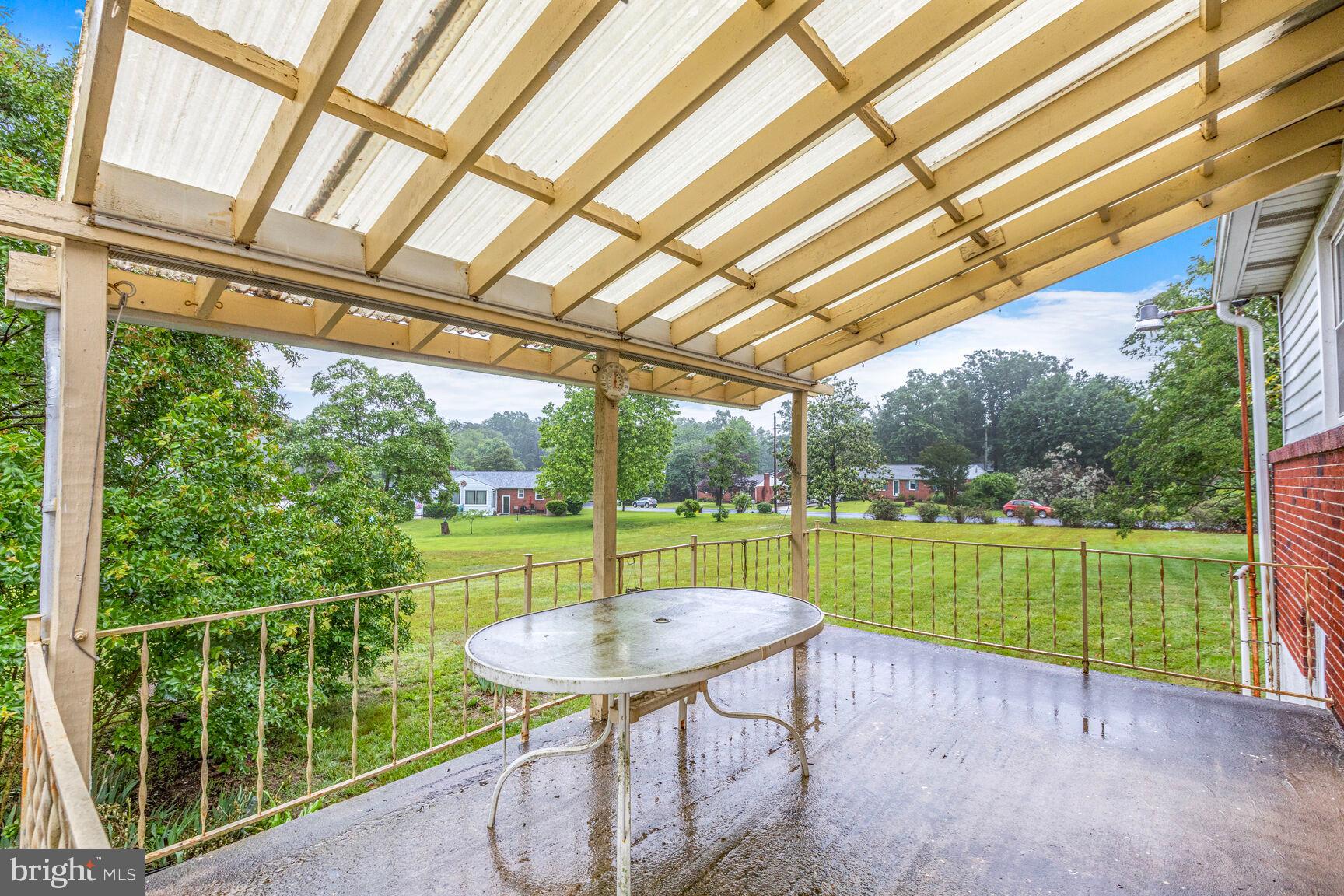 7423 Phelps Road Hanover, MD 21076 - Photo 26 of 28 a view of a patio with a table chairs and a backyard