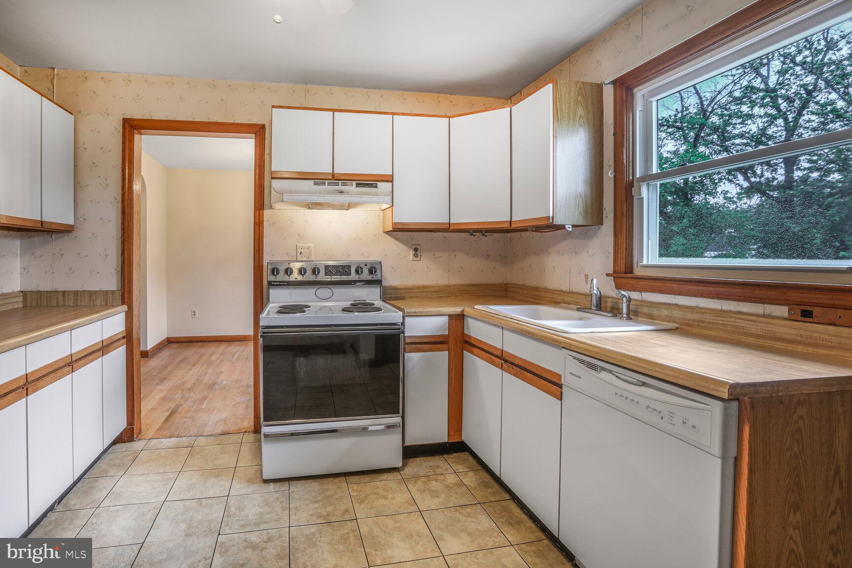 7423 Phelps Road Hanover, MD 21076 - Photo 9 of 28 a kitchen with a stove sink and cabinets