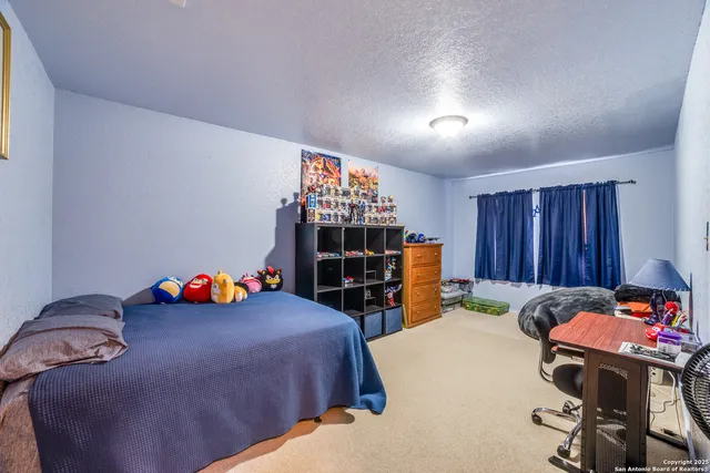 a bedroom with furniture and a chair