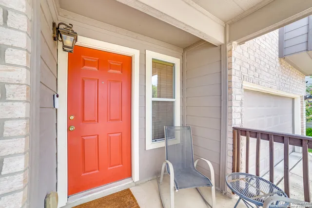 a view of a door and chair in the balcony