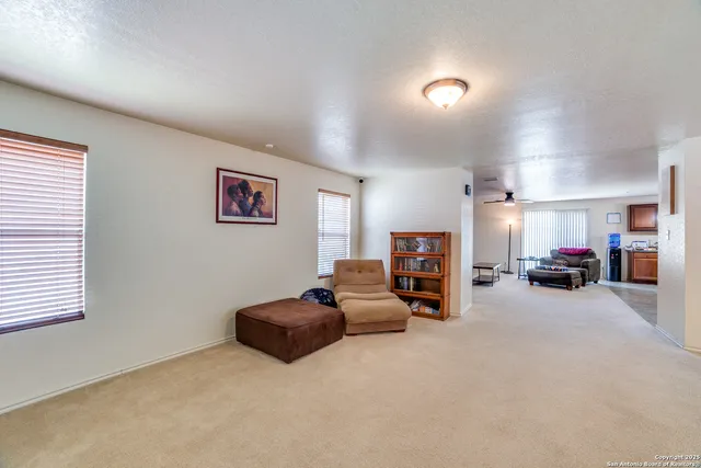 a view of a livingroom with furniture and a large window