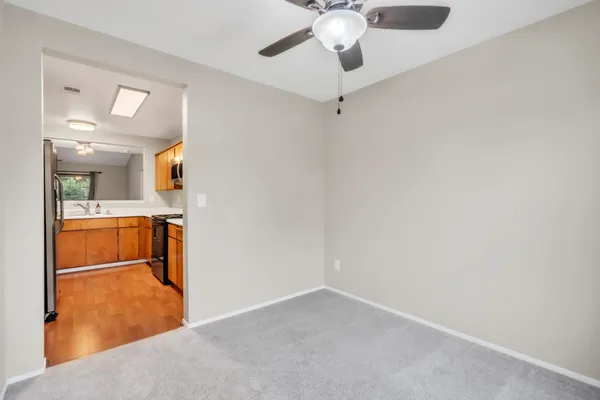a view of a hallway with a livingroom and furniture