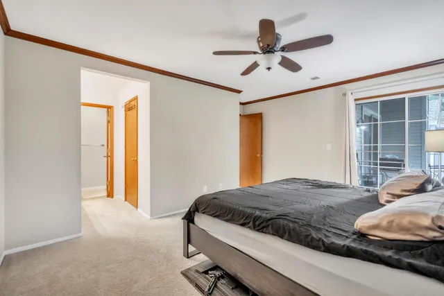 a bedroom with a bed and a ceiling fan