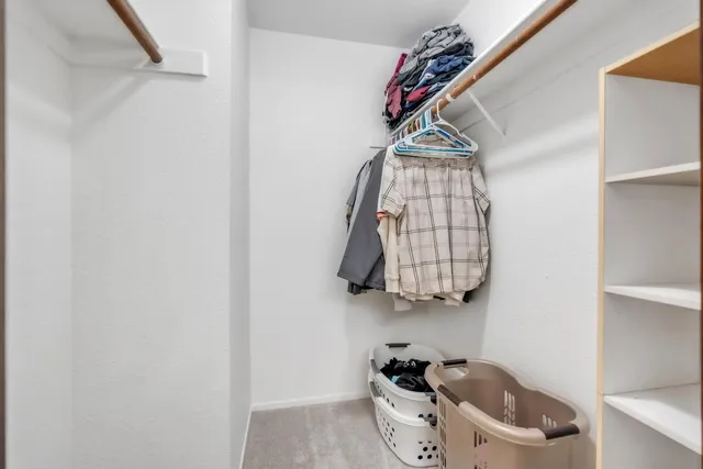 a bedroom with furniture and a chandelier fan