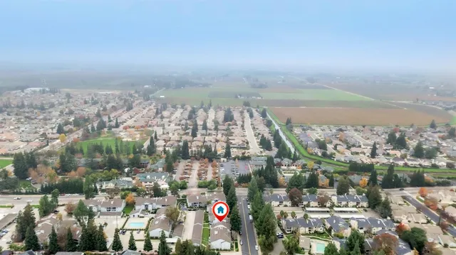 an aerial view of a house with a yard and a garage
