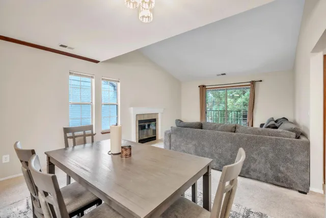 a view of a dining room with furniture and a fireplace