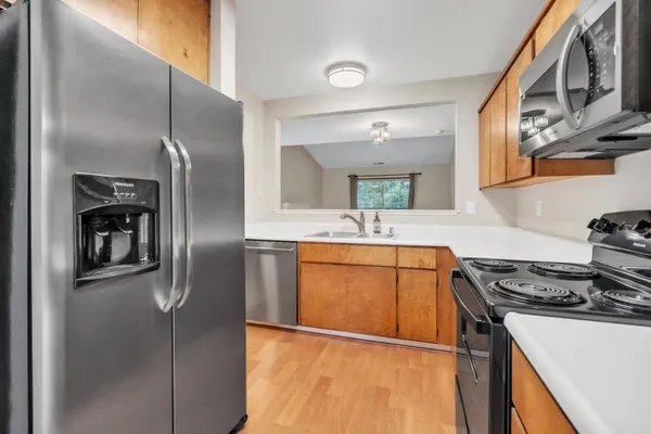 a kitchen with stainless steel appliances granite countertop a refrigerator and a sink