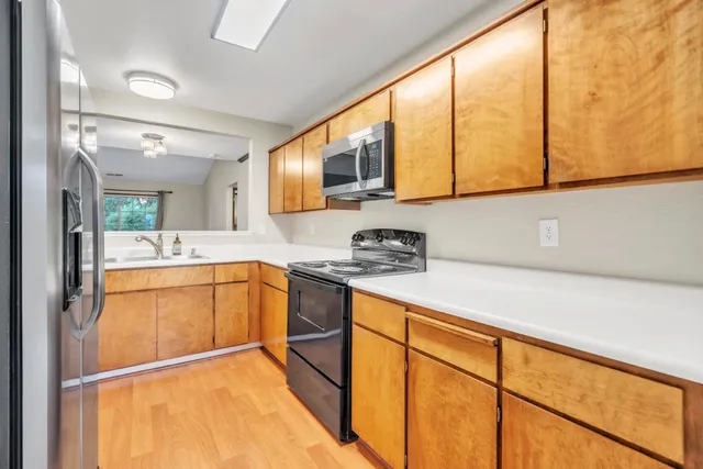 a kitchen with stainless steel appliances granite countertop sink and cabinets