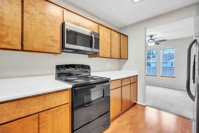a kitchen with stainless steel appliances granite countertop a stove and a microwave