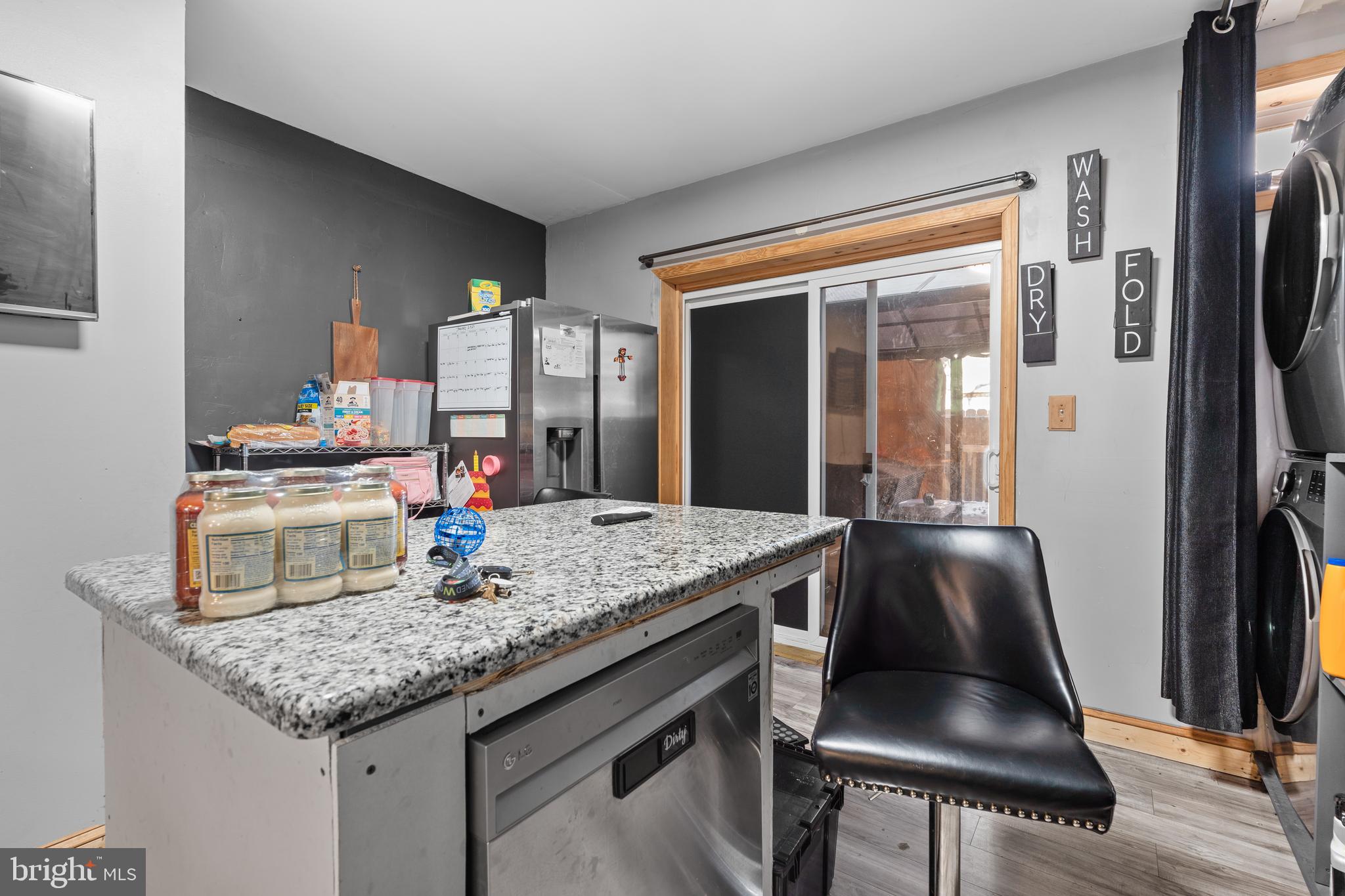 5129 Keyser Street Philadelphia, PA 19144 - Photo 8 of 13 a kitchen with stainless steel appliances granite countertop a sink dishwasher and a refrigerator