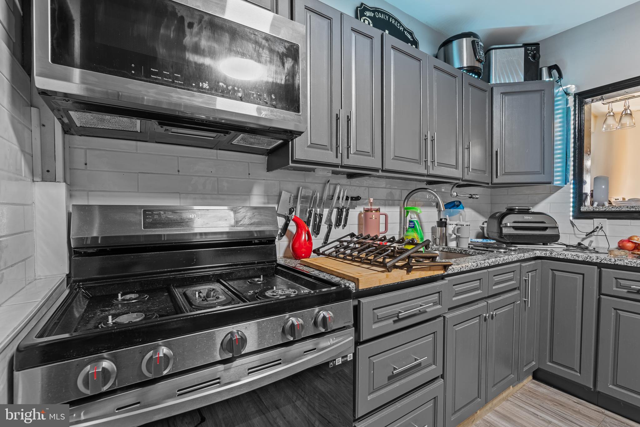 5129 Keyser Street Philadelphia, PA 19144 - Photo 9 of 13 a kitchen with stainless steel appliances granite countertop a stove and cabinets