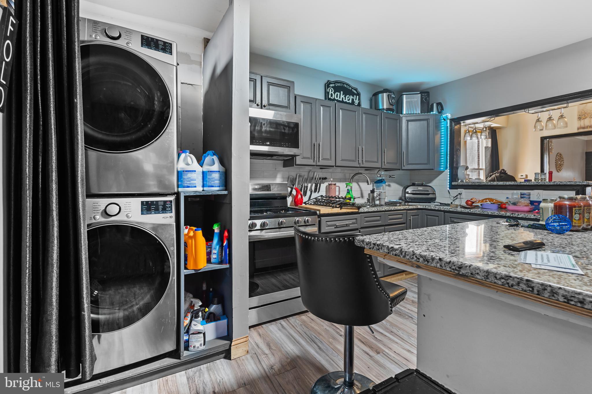 5129 Keyser Street Philadelphia, PA 19144 - Photo 10 of 13 a kitchen with a sink a stove and a wooden cabinets