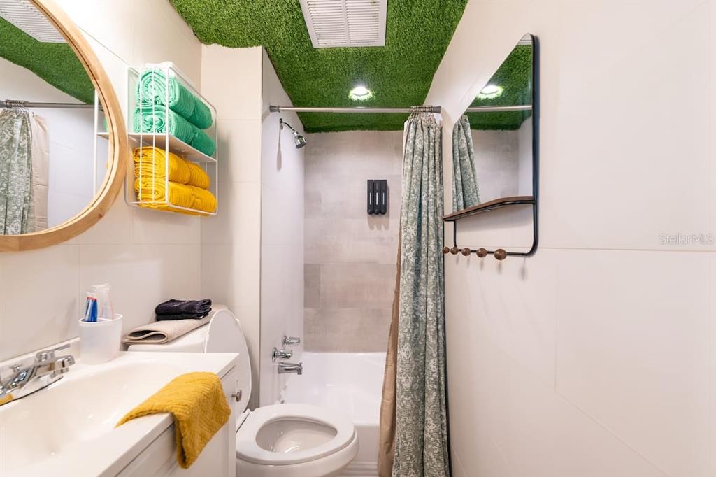 1233 North Atlantic Avenue, Unit 3140 Daytona Beach, FL 32118 - Photo 25 of 33 a bathroom with a sink mirror and tub