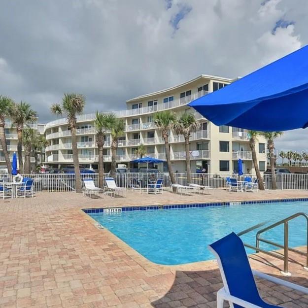 1233 North Atlantic Avenue, Unit 3140 Daytona Beach, FL 32118 - Photo 4 of 33 a view of a swimming pool with outdoor seating