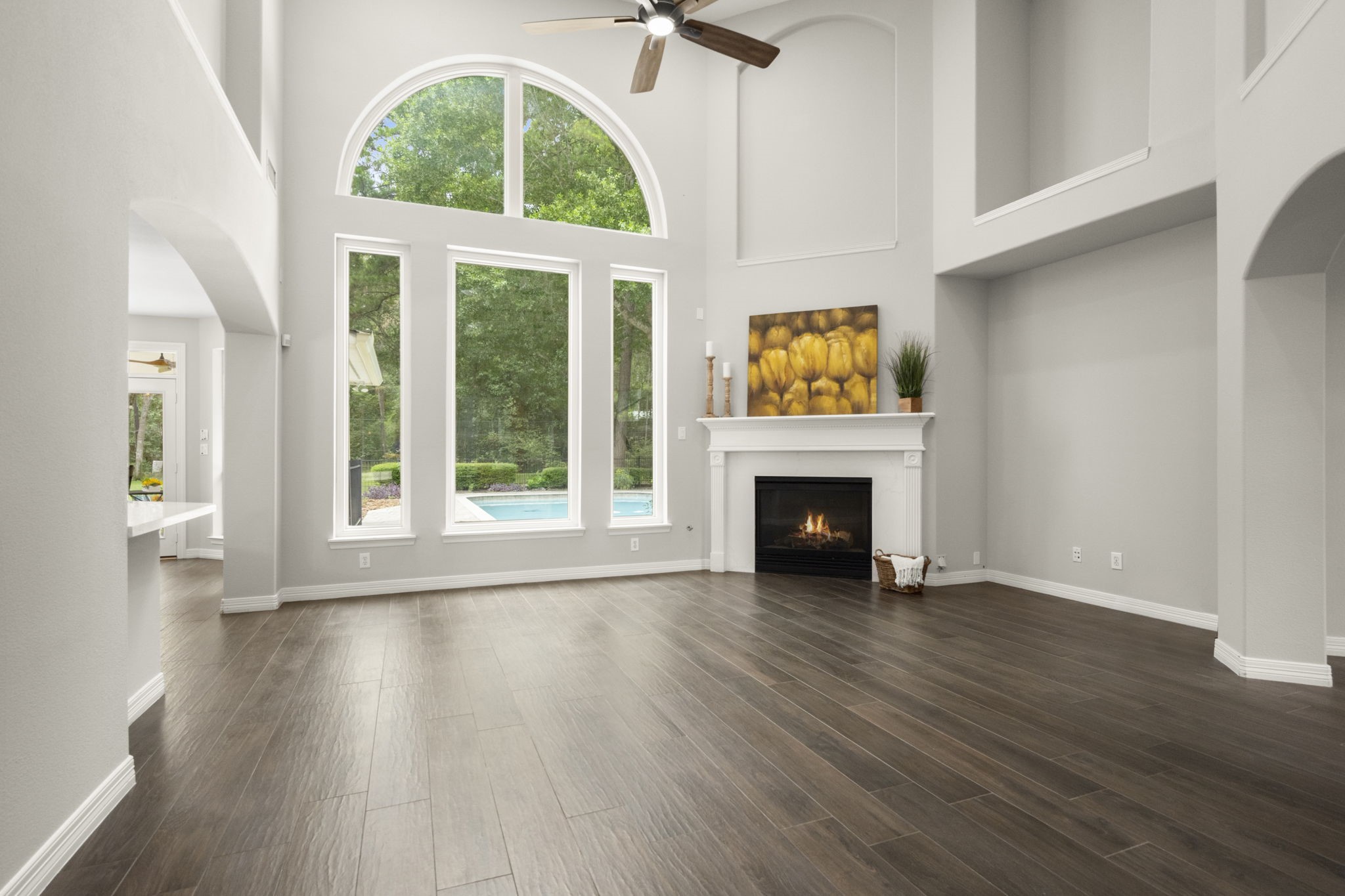 2326 Timbergreen Circle Magnolia, TX 77355 - Photo 7 of 43 an empty room with wooden floor fireplace and windows