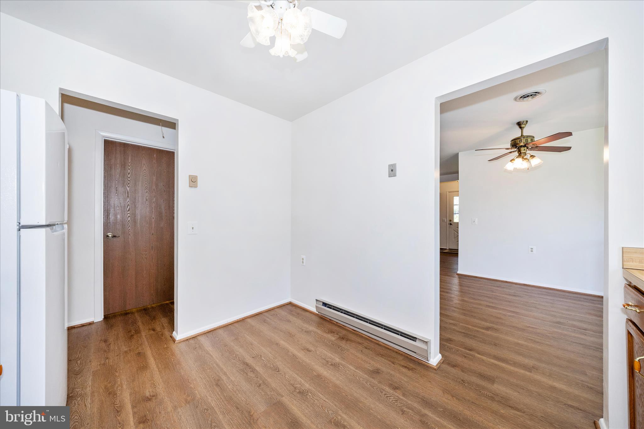 5738 Box Elder Court Frederick, MD 21703 - Photo 16 of 50 an empty room with wooden floor chandelier fan and windows