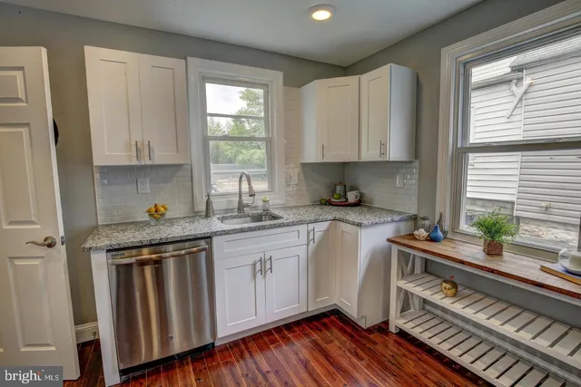 a kitchen that has a sink and a stove in it
