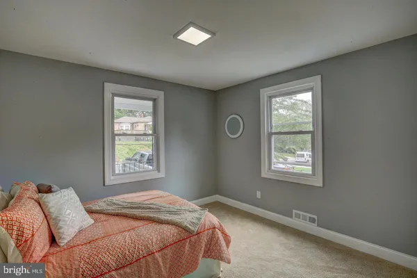 a bed sitting in a bedroom next to a window