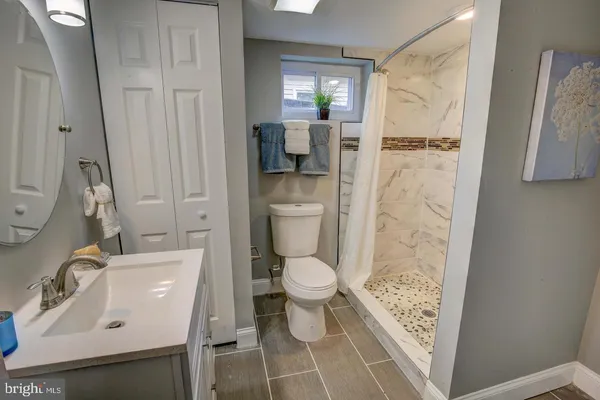a bathroom with a sink toilet and shower