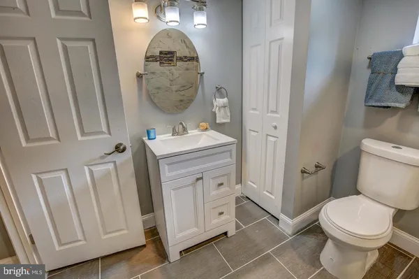 a bathroom with a toilet a sink and a mirror