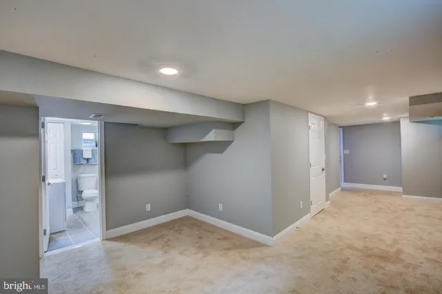 an empty room with windows and bathroom