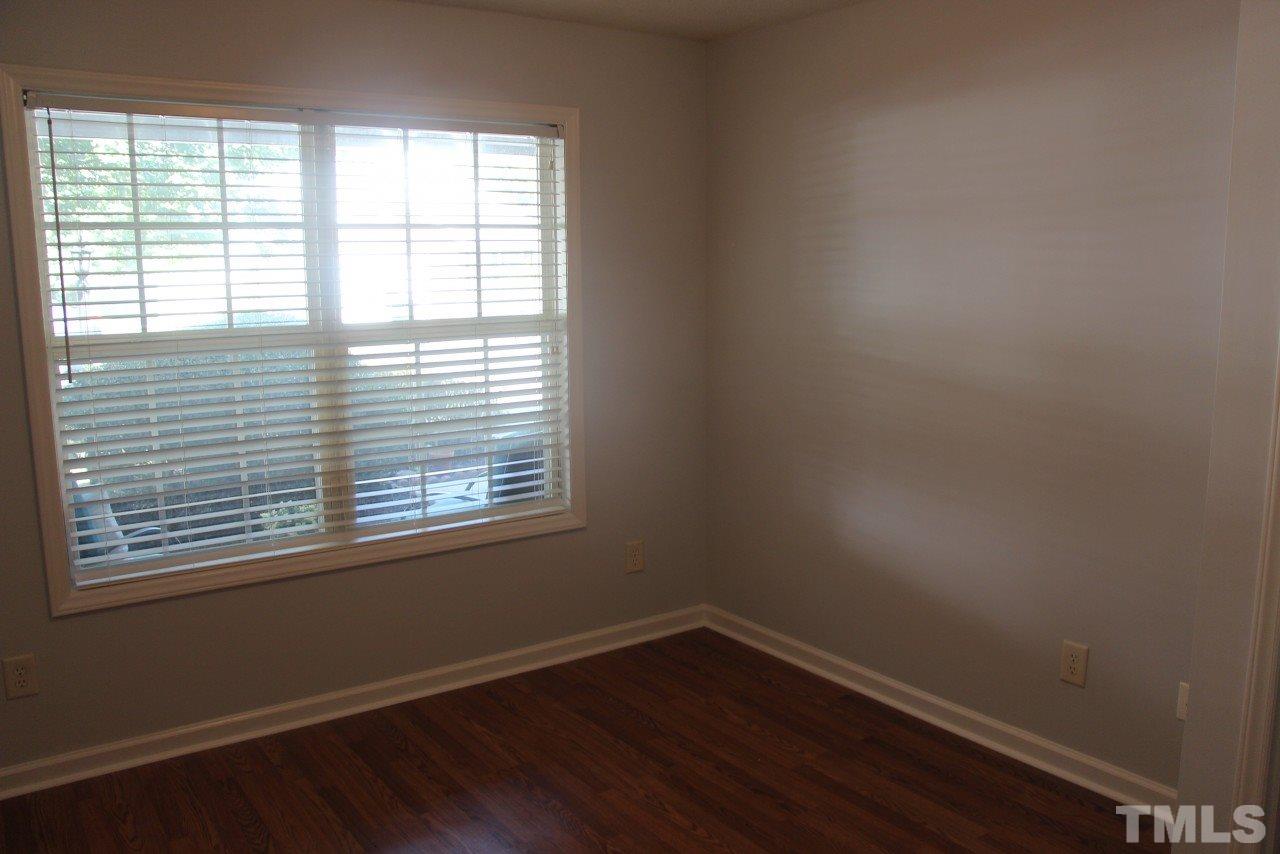 10 Pendleton Court Durham, NC 27713 - Photo 3 of 16 an empty room with wooden floor and windows