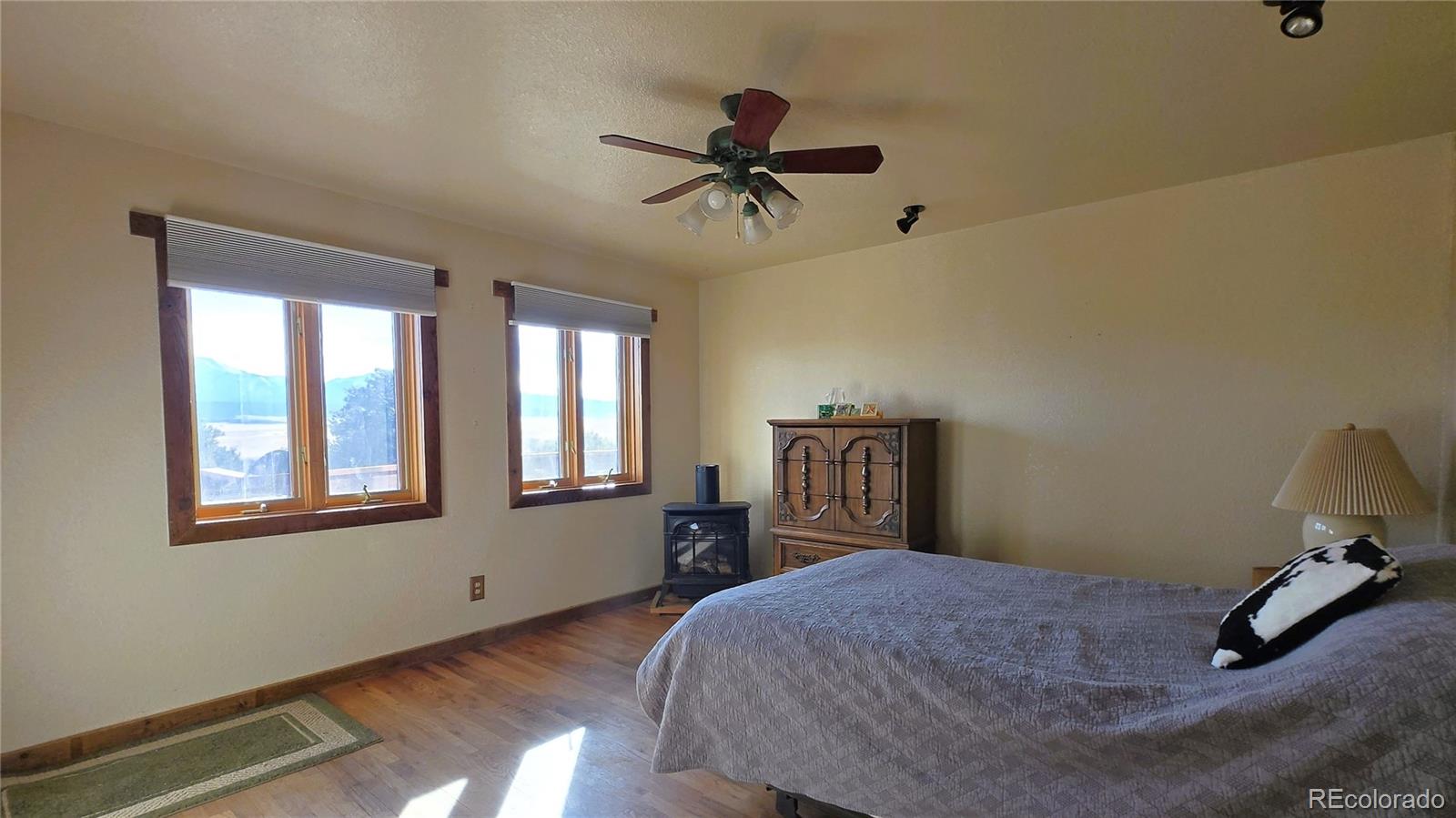 957 Vega Road Walsenburg, CO 81089 - Photo 17 of 30 a bedroom with a bed and wooden floor